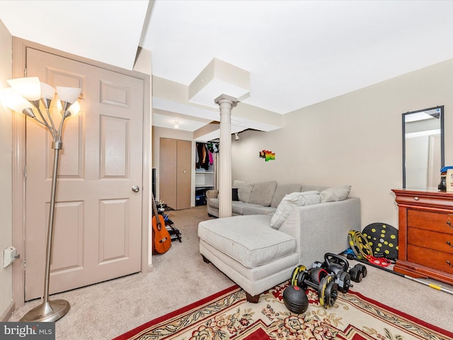 carpeted living room with decorative columns