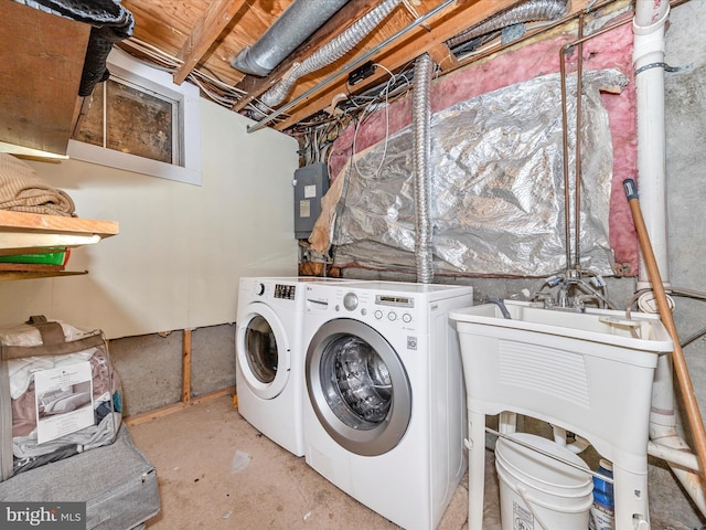 laundry room featuring electric panel and separate washer and dryer