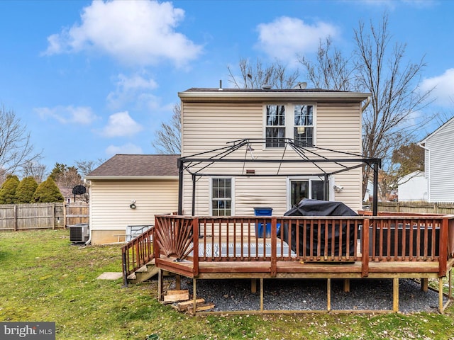 back of property featuring cooling unit, a wooden deck, and a lawn