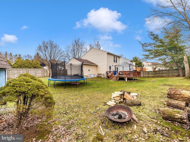 view of yard with a gazebo, a trampoline, and an outdoor fire pit