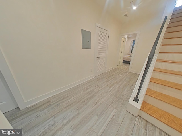 interior space with wood-type flooring and electric panel