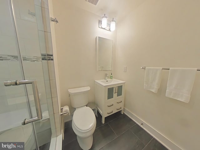 bathroom featuring vanity, an enclosed shower, tile patterned floors, and toilet