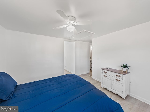 bedroom featuring ceiling fan, light wood-style flooring, attic access, and baseboards