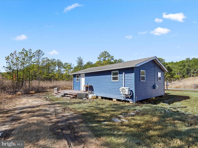 back of house featuring an outbuilding and a yard