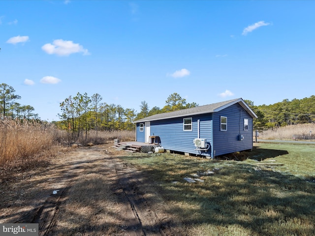 exterior space with an outbuilding and a lawn