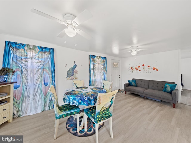 dining room with a ceiling fan and wood finished floors