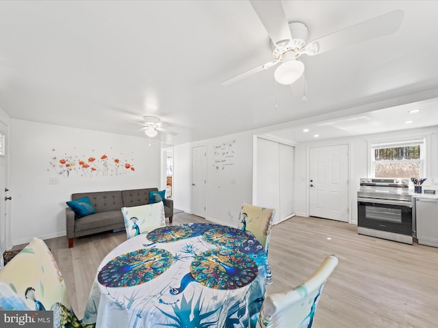 bedroom featuring a ceiling fan, two closets, light wood-style flooring, and baseboards