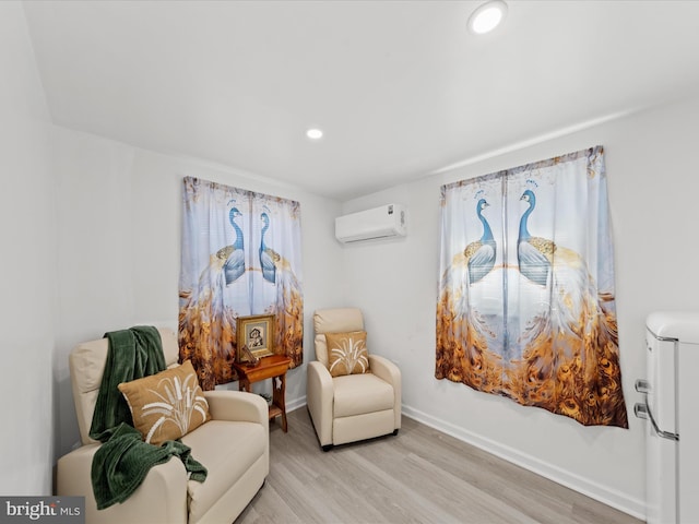 living area with light wood-style floors, recessed lighting, baseboards, and a wall mounted air conditioner