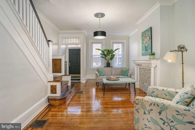 living area with hardwood / wood-style flooring and ornamental molding