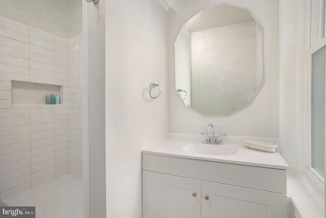 bathroom featuring vanity and a tile shower