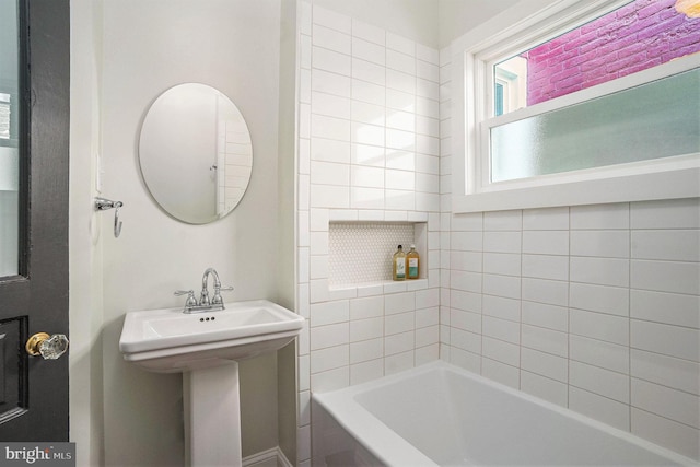 bathroom with a bathing tub and sink