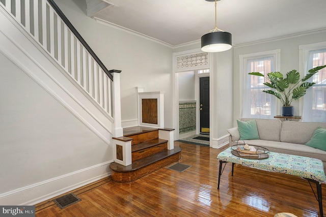 living room with ornamental molding and hardwood / wood-style floors