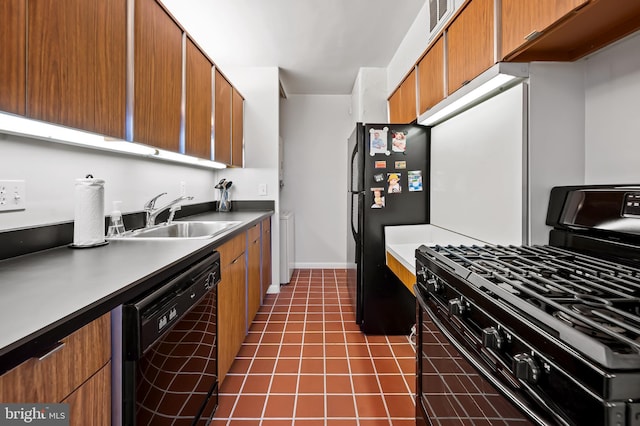 kitchen with sink, black appliances, and dark tile patterned floors