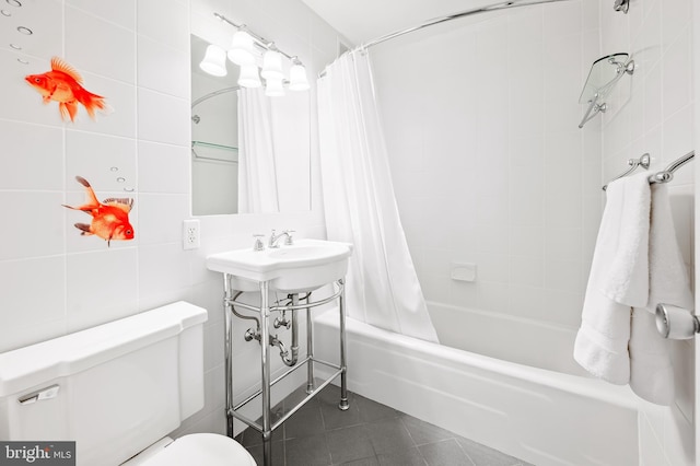 full bathroom with shower / tub combo with curtain, toilet, sink, tile walls, and tile patterned flooring