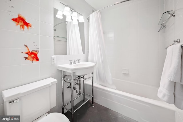 bathroom with tile patterned floors, toilet, tile walls, and shower / bath combo