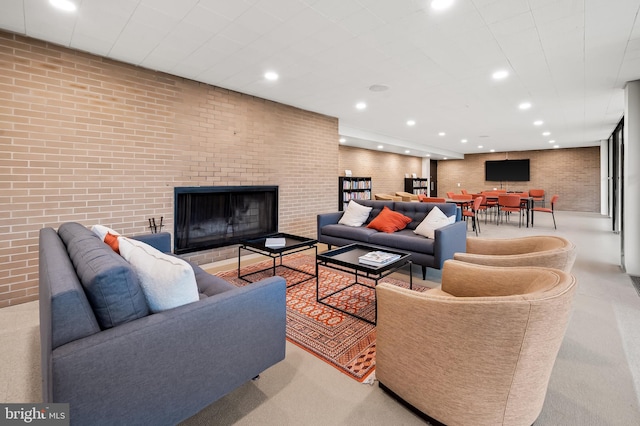 living room with brick wall and a brick fireplace