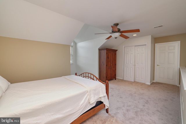 carpeted bedroom with vaulted ceiling, ceiling fan, and a closet