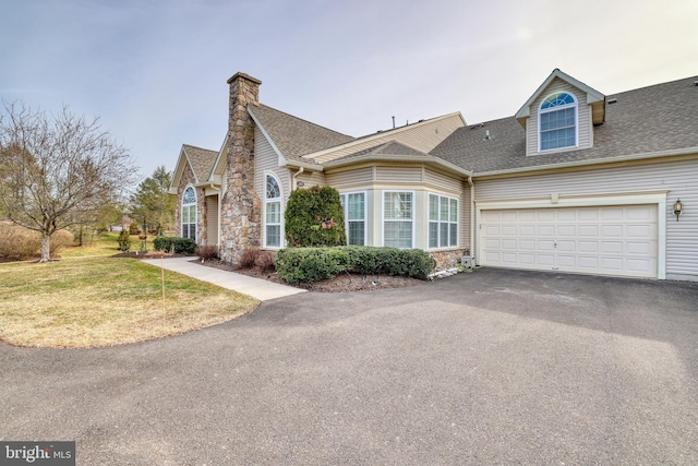 view of front of property with a garage and a front lawn