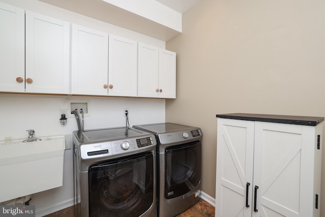 laundry room featuring cabinets, washer and dryer, and sink