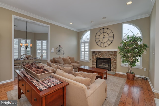 living room with ornamental molding, plenty of natural light, and light hardwood / wood-style floors