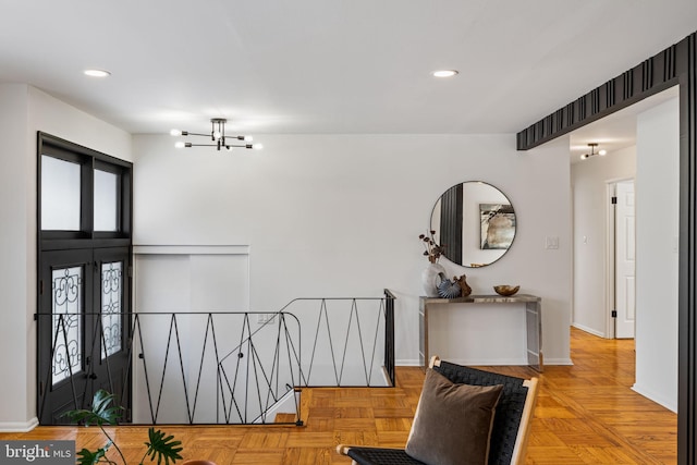 foyer featuring a notable chandelier and light parquet flooring