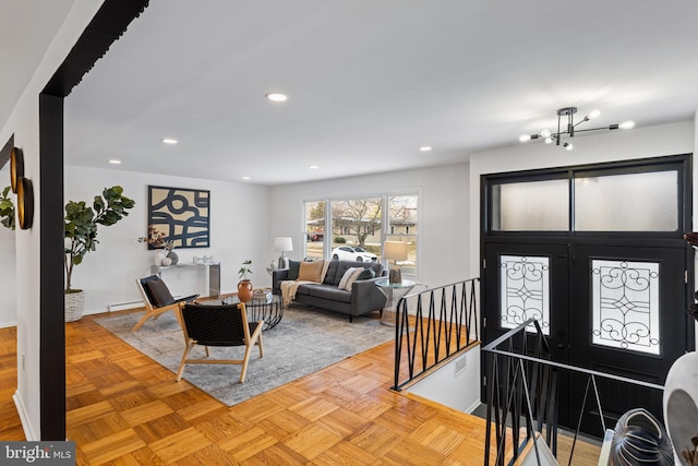 foyer entrance featuring baseboard heating and light parquet flooring