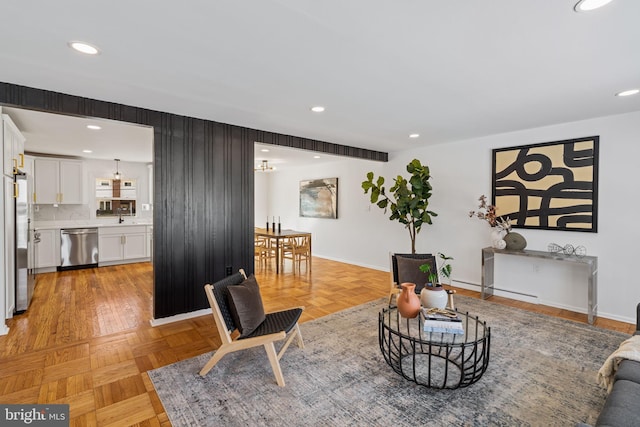 living room featuring sink and light parquet flooring