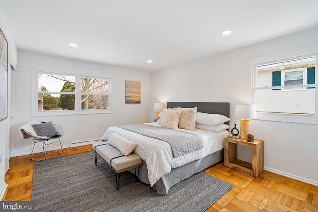 bedroom with light parquet floors and baseboard heating