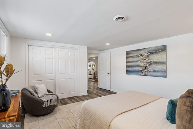 bedroom featuring hardwood / wood-style flooring and a closet