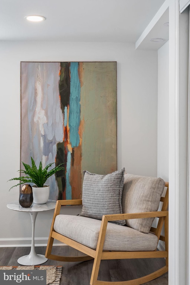 sitting room with wood-type flooring