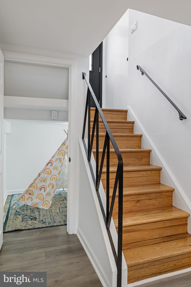 stairs with wood-type flooring