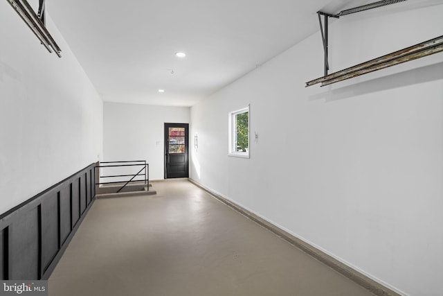 hall featuring concrete flooring