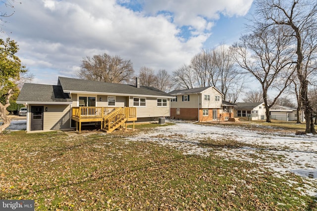 snow covered house featuring a yard, central AC, and a deck