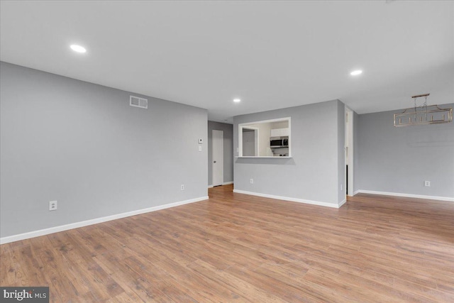 unfurnished living room with light wood-type flooring