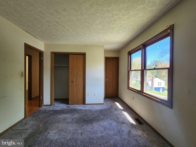 6212 8th St, Chesapeake Beach, MD 20732 - unfurnished bedroom featuring carpet flooring and a textured ceiling