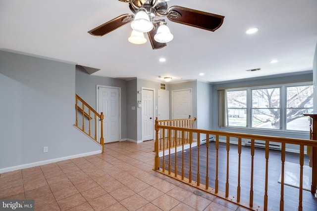 interior space featuring visible vents, recessed lighting, light tile patterned flooring, baseboards, and stairs