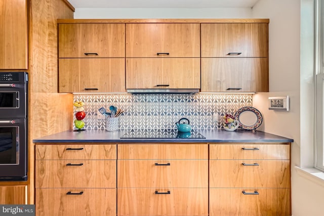 kitchen with black appliances, dark countertops, and decorative backsplash
