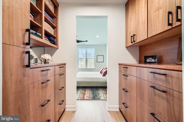 hallway with light wood-style floors, recessed lighting, and baseboards