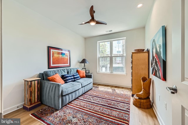 sitting room featuring ceiling fan, baseboards, wood finished floors, and visible vents