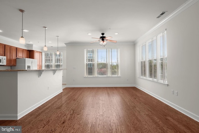 unfurnished living room with crown molding, visible vents, a healthy amount of sunlight, recessed lighting, and a ceiling fan