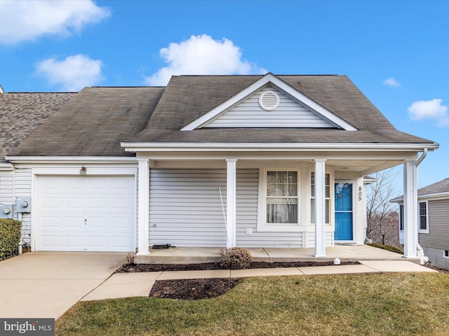 view of front of home with a porch, a garage, and a front yard