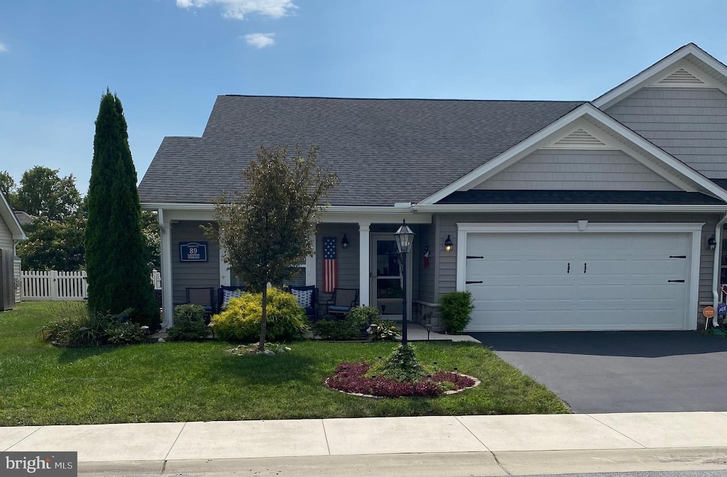 view of front of property with a garage and a front lawn