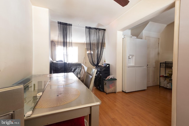 kitchen with ceiling fan, light hardwood / wood-style floors, and white fridge with ice dispenser