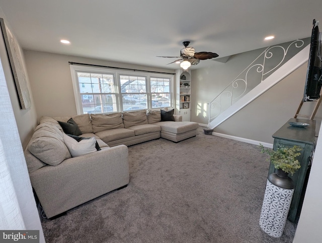 carpeted living room with ceiling fan