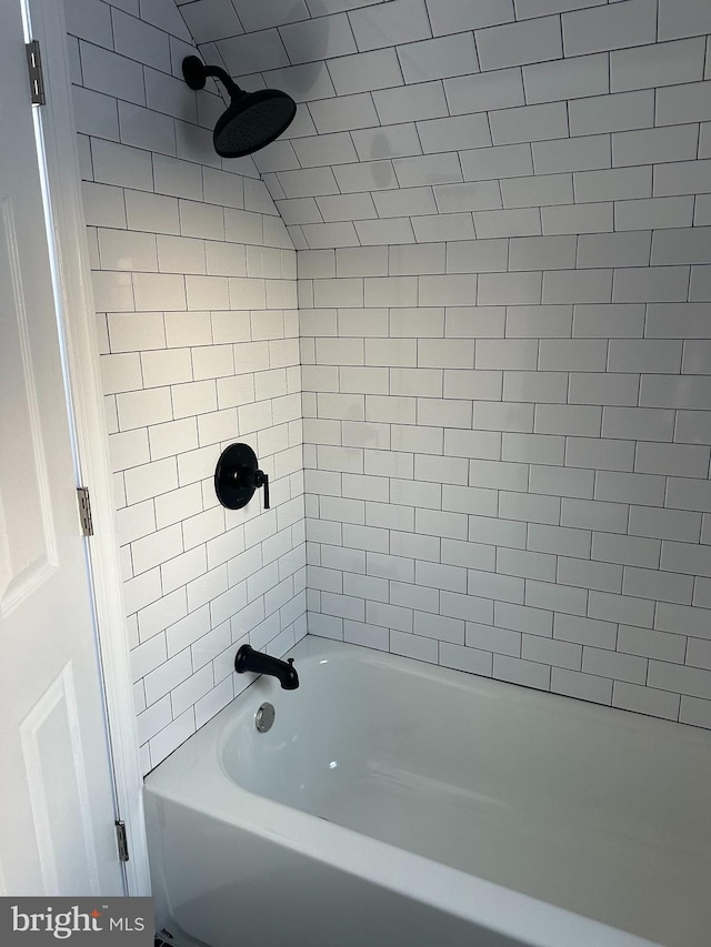 bathroom with bathing tub / shower combination