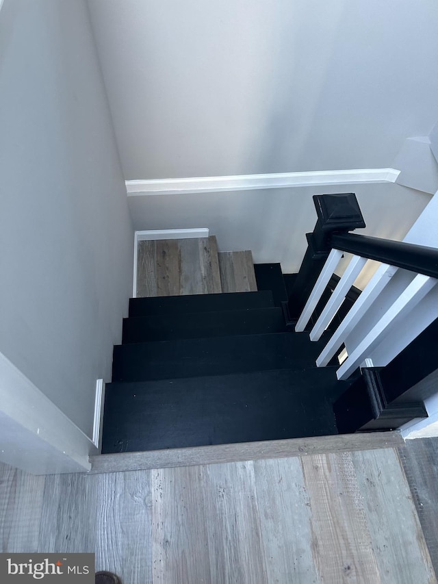 stairway with wood finished floors