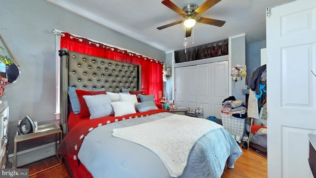 bedroom with ceiling fan, a closet, and wood finished floors