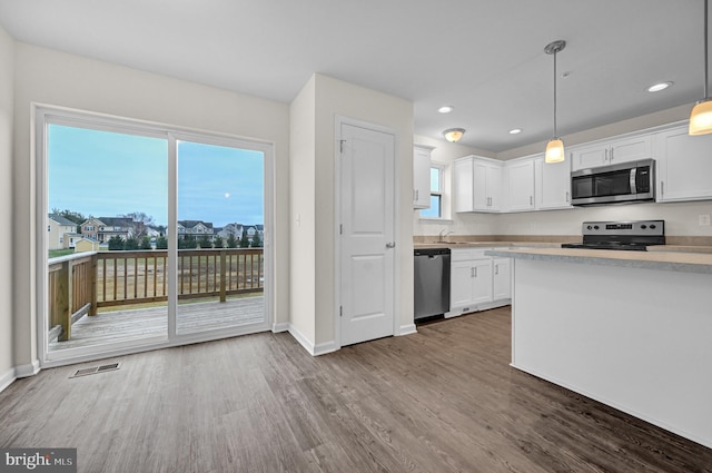 4 Landing Pl Unit 4, York, PA 17408 - kitchen featuring white cabinetry, appliances with stainless steel finishes, hardwood / wood-style flooring, and pendant lighting