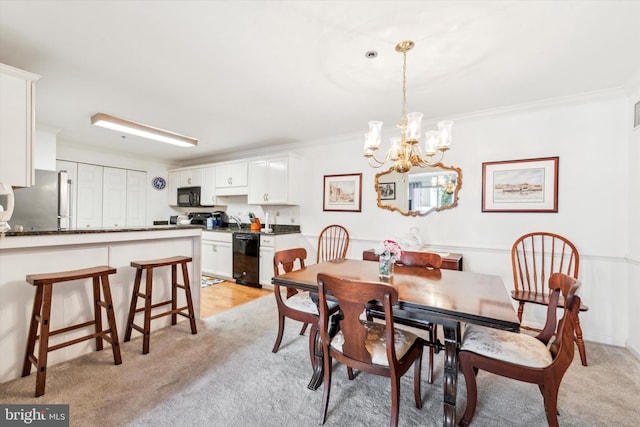 carpeted dining space with crown molding, sink, and a chandelier