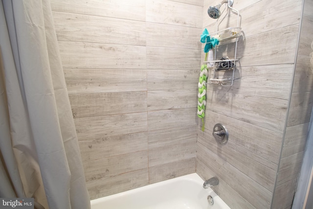 bathroom with shower / bath combo with shower curtain